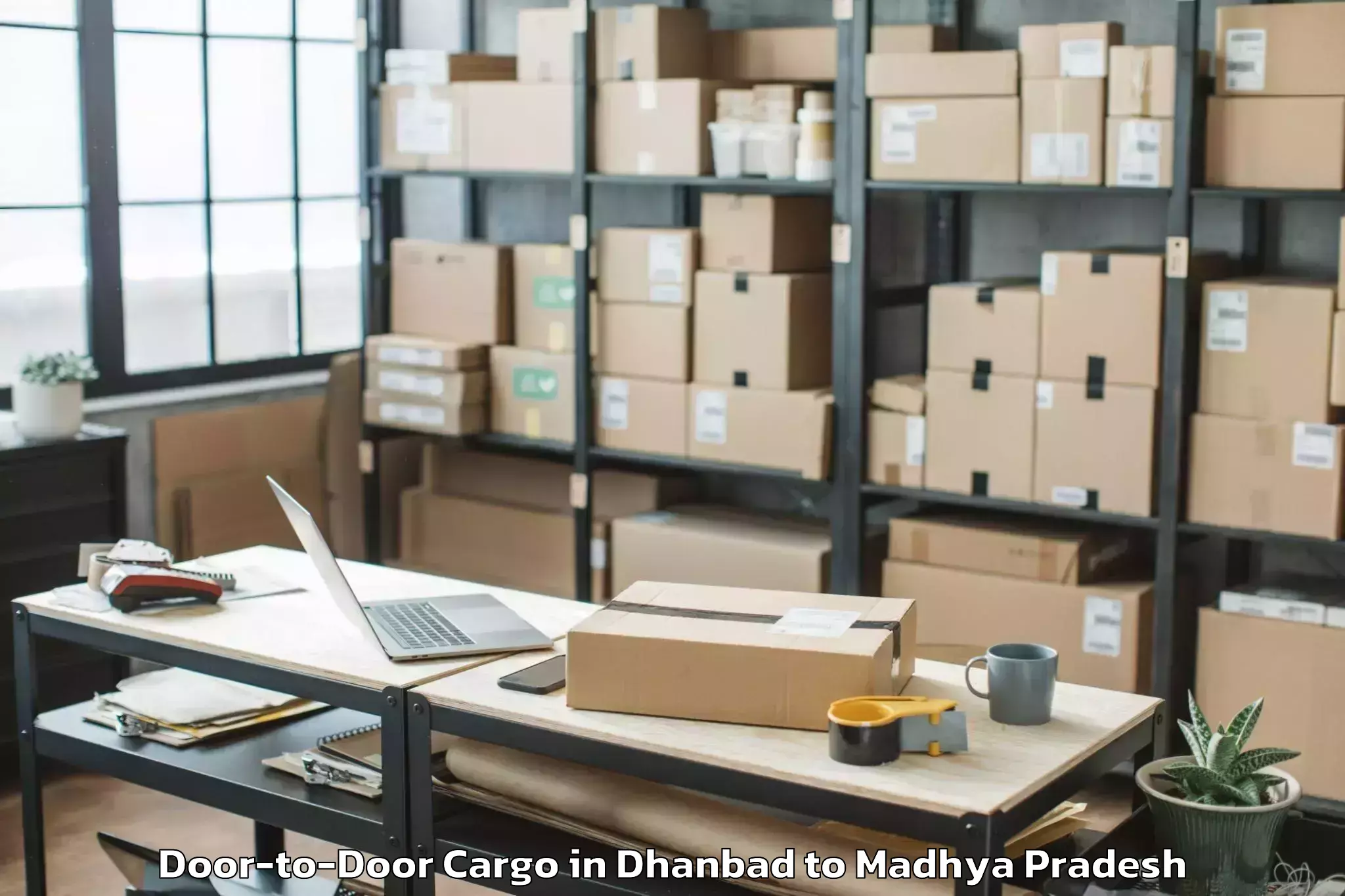 Leading Dhanbad to Bagli Door To Door Cargo Provider